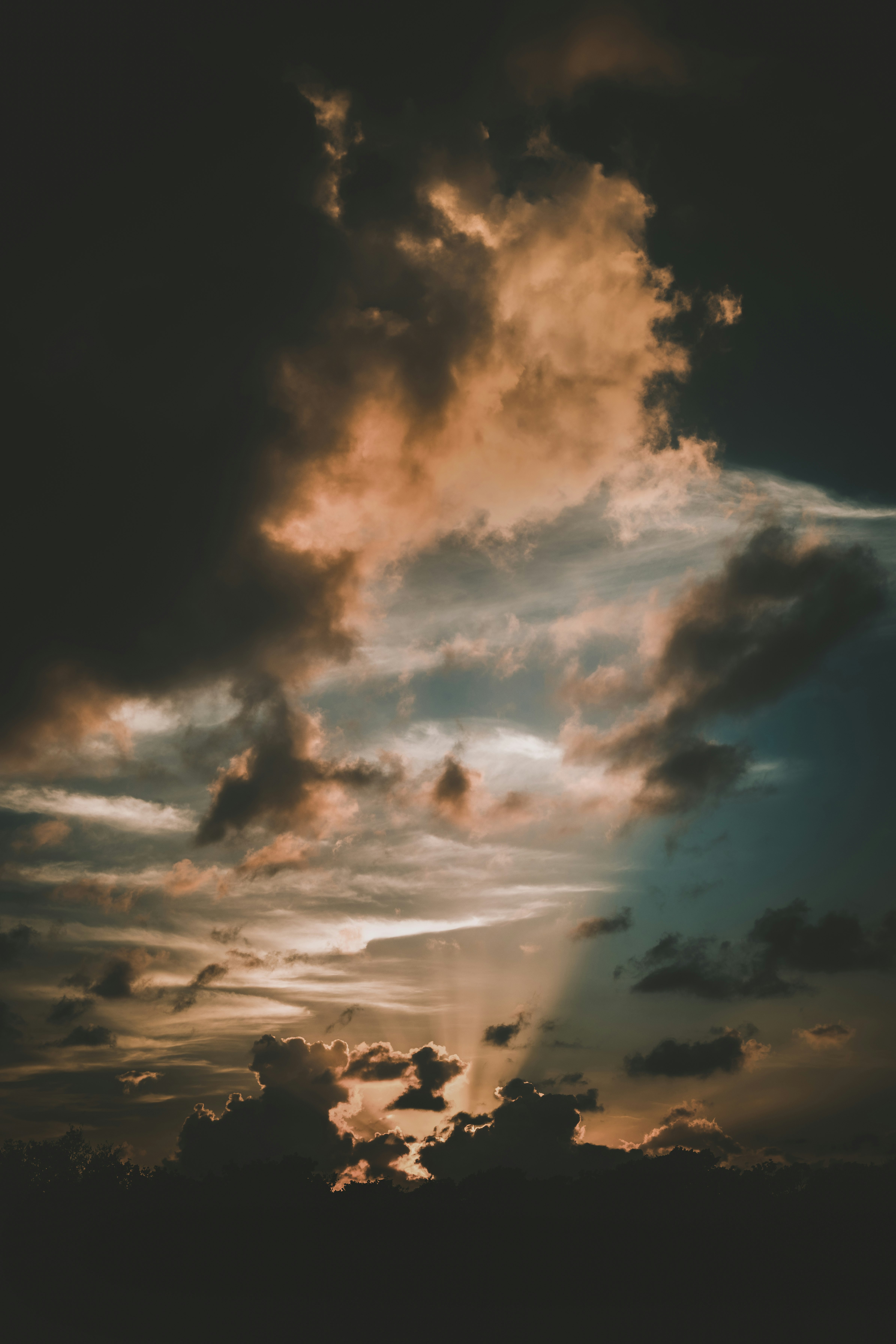 silhouette of people under cloudy sky during daytime